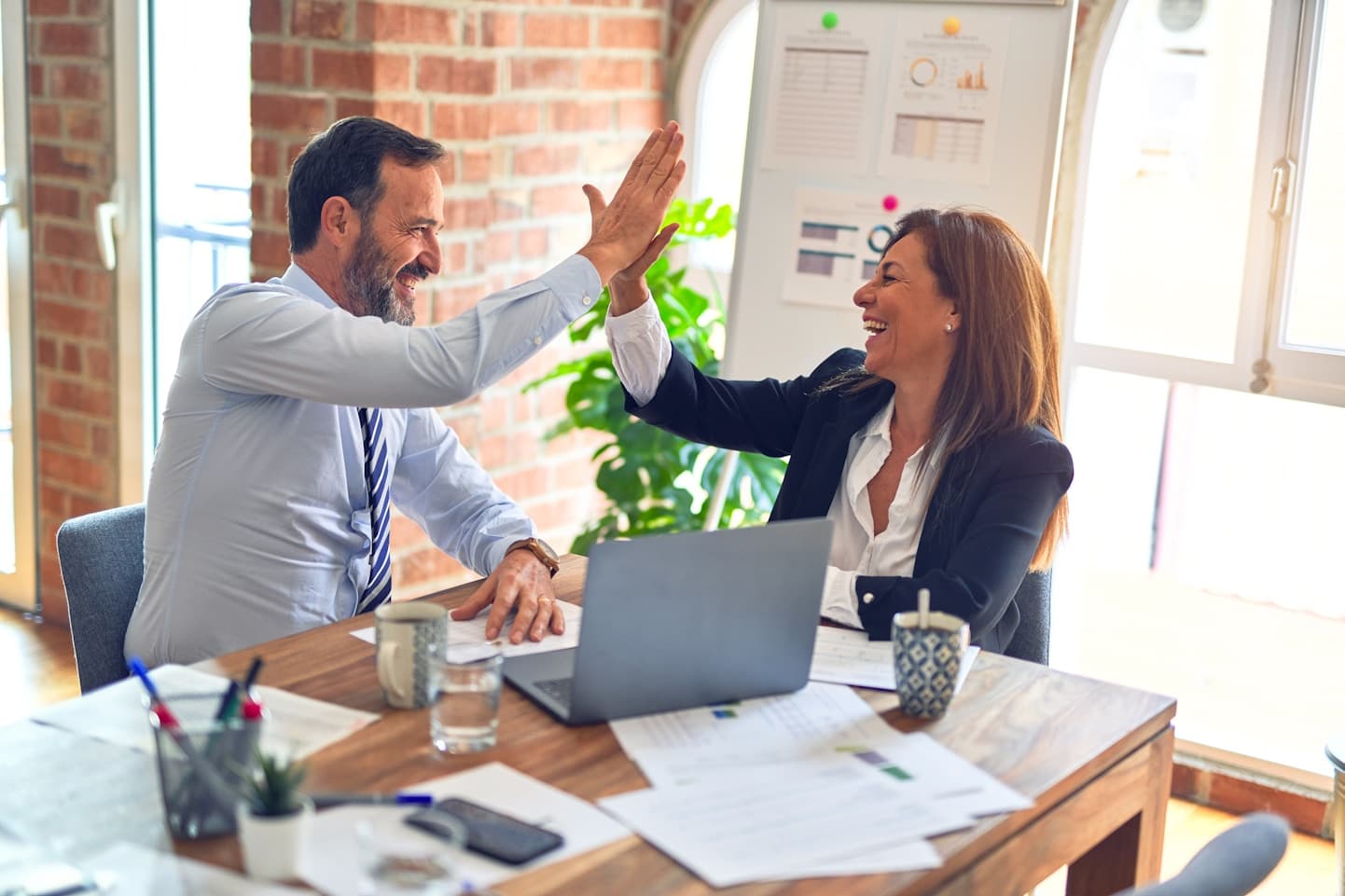 People hi-fiving at a meeting